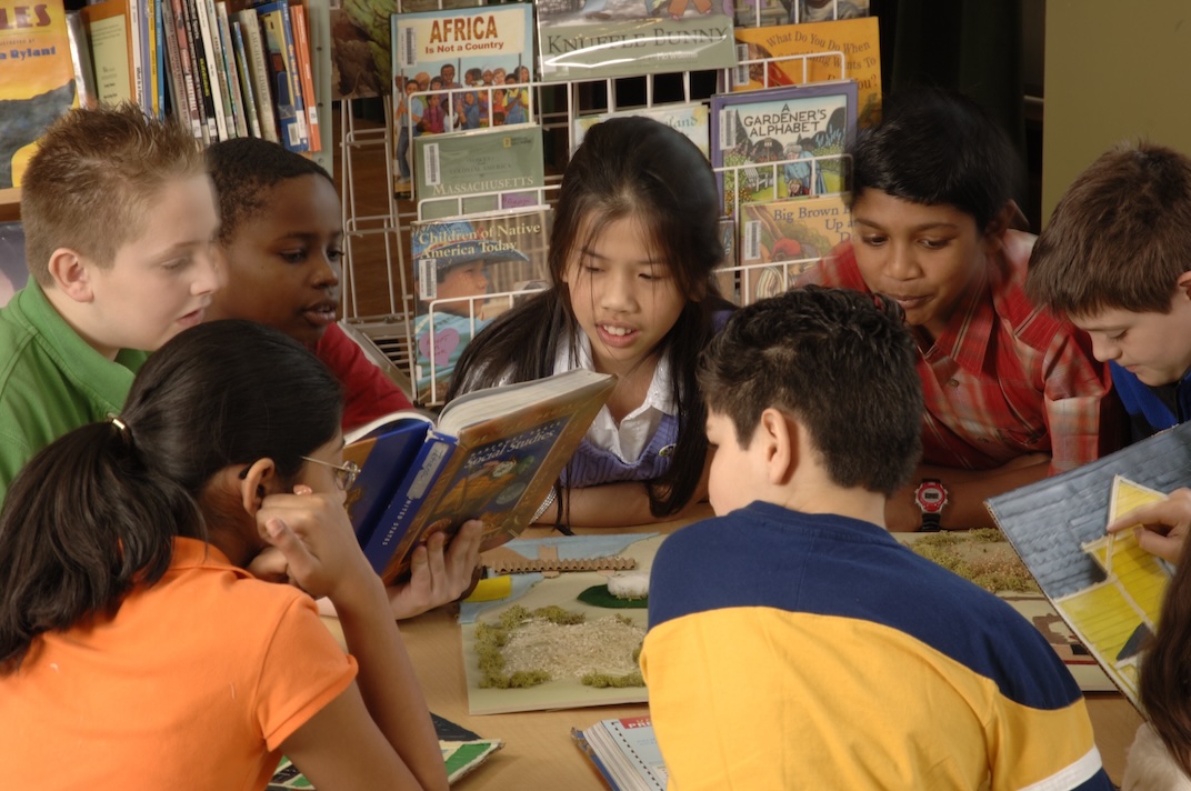 Students circled around several books of interest